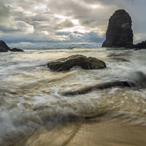 Swirling water around rocks on a beach