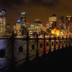 Sydney skyline at night with the Sydney Harbour in the foreground. Sydney. NSW. AUSTRALIA