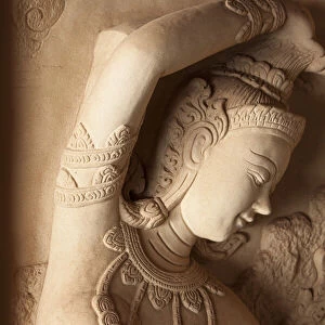 Thailand, Ko Samui. Carved stone relief of a Hindu deity