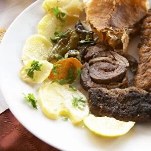 Traditional dish with potatoes, rolled roast lamb, fried fish, kafta meat balls. Berat lower town