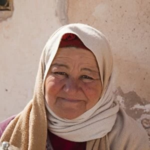 Tunisia, Ksour Area, Metameur, middle-aged Tunisian woman serving tea (MR)