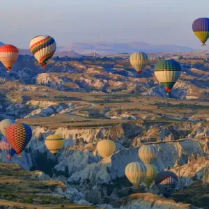 Turkey, Anatolia, Cappadocia, Goreme. Hot air balloons flying above / among rock formations Turkey, Anatolia, Cappadocia, Goreme. Hot air balloons flying above / among rock formations