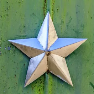 Ukraine, Pripyat, Chernobyl. Decorative silver Soviet star on a green wall