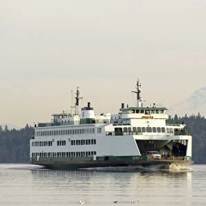 US, WA WSF Seattle / Bremerton ferry passes in front of Mt Rainier