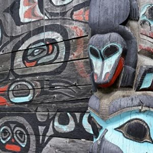 USA; Alaska, Haines. Partial view of Native-American totem pole and wall mural