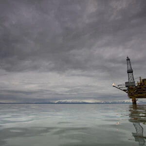USA, Alaska, Kenai Peninsula, Offshore oil drilling rigs in Cook Inlet on summer evening