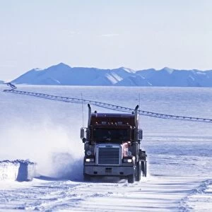 USA, Alaska, North Slope. Truck on the snow-covered Dalton highway with Trans-Alaska