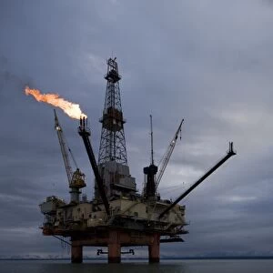 USA, Alaska, Offshore oil drilling rigs with burning natural gas flares in Cook Inlet