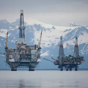 USA, Alaska, Offshore oil drilling rigs in Cook Inlet and distant Alaska Range peaks