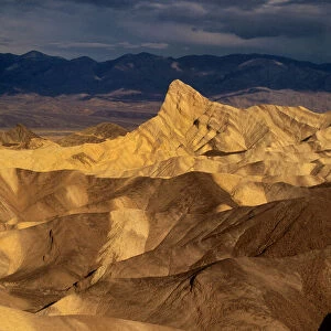 USA, California, Death Valley National Park. Clearing storm over sandstone formations at