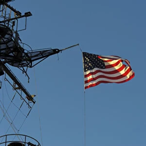 USA, California, San Diego. The American flag flies on board the USS Midway in San Diego