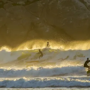 USA, California, San Luis Obispo County. Surfers at sunset USA, California, San Luis Obispo County. Surfers at sunset