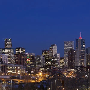 USA, Colorado, Denver, city view from the west at dusk with Elitch Gardens theme