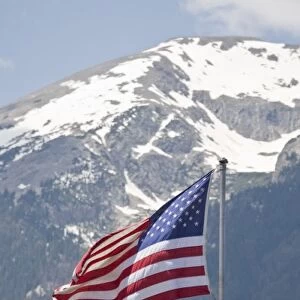 USA, Colorado, Silverthorne. American flag flying against mountain backdropFred J