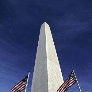 USA, District of Columbia. Waving American flags accent the stately Washington Monument
