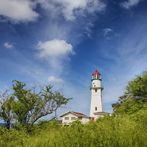 USA; Hawaii; Oahu; Morning light on Diamond Head Lighthouse with Puffy Clouds
