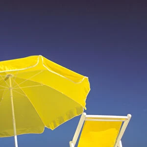 USA, Hawaiian Islands. Beach chair and umbrella on beach