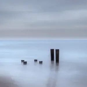 USA, New Jersey, Cape May National Seashore. Beach pilings on stormy sunrise. Credit as USA, New Jersey, Cape May National Seashore. Beach pilings on stormy sunrise. Credit as