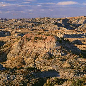 USA, North Dakota, Theodore Roosevelt National Park, Evening light defines eroded