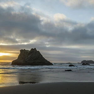 USA, Oregon, Bandon Beach. Wizards Hat and other formations at sunset