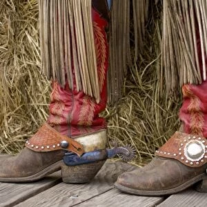 USA, Oregon, Seneca, Ponderosa Ranch. Cowgirls boots with leather fringes hanging from chaps