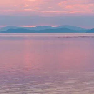 USA, San Juan Islands, Washington State. Colorful reflected sunset sky from Sucia Island view to Strait of Georgia USA, San Juan Islands, Washington State. Colorful reflected sunset sky from Sucia Island view to Strait of Georgia