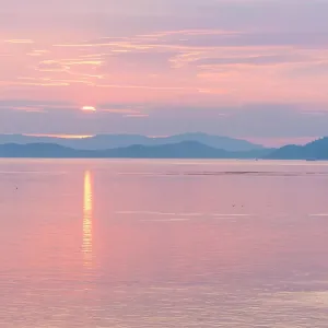 USA, San Juan Islands, Washington State. Colorful reflected sunset sky from Sucia Island view to Strait of Georgia USA, San Juan Islands, Washington State. Colorful reflected sunset sky from Sucia Island view to Strait of Georgia