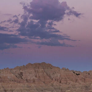 USA, South Dakota, Badlands National Park. Sunrise and moonset over rugged landscape