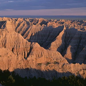 USA, South Dakota, Badlands National Park, North Unit, Sunset light on expansive area of eroded