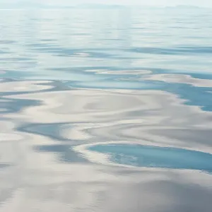 USA, Strait of Georgia. Cloud patterns reflection on calm Salish Sea USA, Strait of Georgia. Cloud patterns reflection on calm Salish Sea