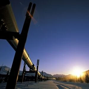USA, USA, Alaska, Brooks Range. Winter sun sets over the Trans-Alaska Oil Pipeline
