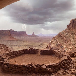USA, Utah, Canyonlands National Park. View of Anasazi ruin with thundercloud