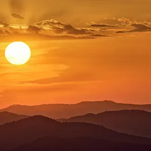 USA, Washington State, Palouse Region. Sunrise from Steptoe Butte with hills and sunrays