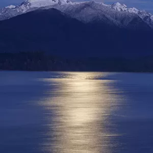 USA, Washington State, Seabeck. Moon over Olympic Mountains and Hood Canal at sunrise