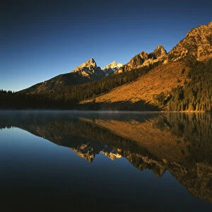 USA, Wyoming, Grande Teton National Park, Cathedral group mountain reflecting in