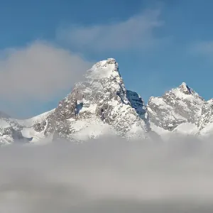 USA, Wyoming, Jackson. Grand Teton National Park, Fog hovers beneath Middle Teton, Grand Teton, and Mount Owen in the Teton Range USA, Wyoming, Jackson. Grand Teton National Park, Fog hovers beneath Middle Teton, Grand Teton, and Mount Owen in the Teton Range