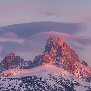 USA, Wyoming. Panoramic landscape of alpenglow over Teton Range from the west with cirrus cloud USA, Wyoming. Panoramic landscape of alpenglow over Teton Range from the west with cirrus cloud
