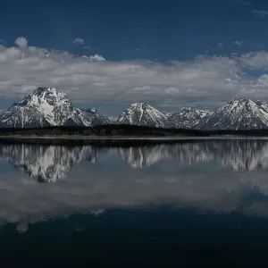 USA, Wyoming. Panoramic landscape of Teton Mountains reflected in Jackson Lake in springtime