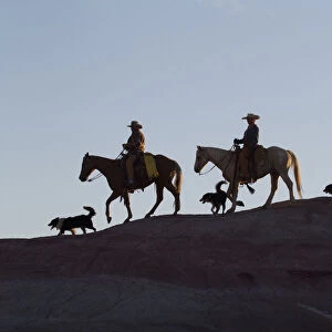 USA, Wyoming, Shell, The Hideout Ranch, Cowboys, Horses and Dogs in Early Light on Ridgeline