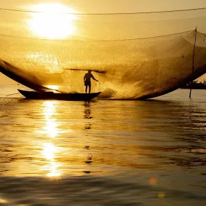Vietnam. Fisherman emptying the nights catch in the Lagoon