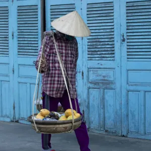 Vietnam. Street vendor with fruit and vegetable basket. Hoi Anh Vietnam. Street vendor with fruit and vegetable basket. Hoi Anh