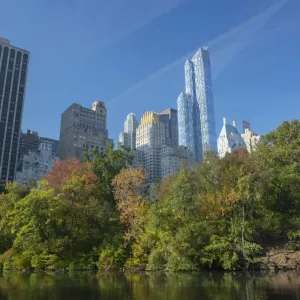 View of highrise buildings along Central Park South from inside Central Park on a sunny Fall day View of highrise buildings along Central Park South from inside Central Park on a sunny Fall day