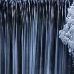 Water flowes by ice formation along Falls Creek in winter near Nelson, British Columbia Water flowes by ice formation along Falls Creek in winter near Nelson, British Columbia