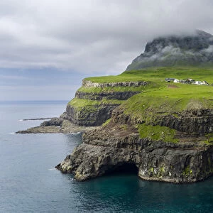 The waterfall near Gasadalur, one of the landmarks of Faroe Islands. The island Vagar