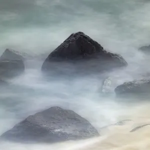Waves crashing over lava rocks on shoreline of Espanola Island, Galapagos Islands, Ecuador