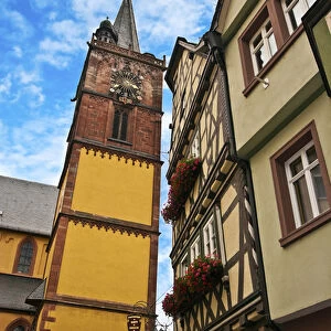 Wertheim, Franconia, Germany, A clock tower sits next to medieval Cross Timbered Houses