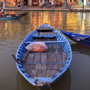 Wooden boats moored on the Thu Bon River opposite Bach Dang Street in the old town of Hoi An