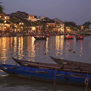 Wooden boats moored on the Thu Bon River opposite Bach Dang Street in the old town of Hoi An