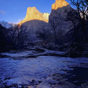 Zion National Park, Utah. USA. Light of sunrise on towers of Zion Canyon above Virgin