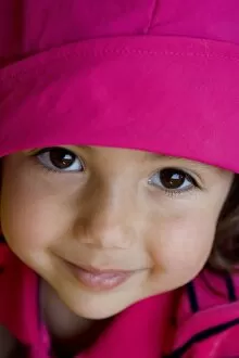 4 year old girl wearing pink and smiling at the camera (MR)